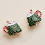 Pair of Christmas Tree Mug stud earrings with glittery green enamel, marshmallow topping, and candy cane accents.