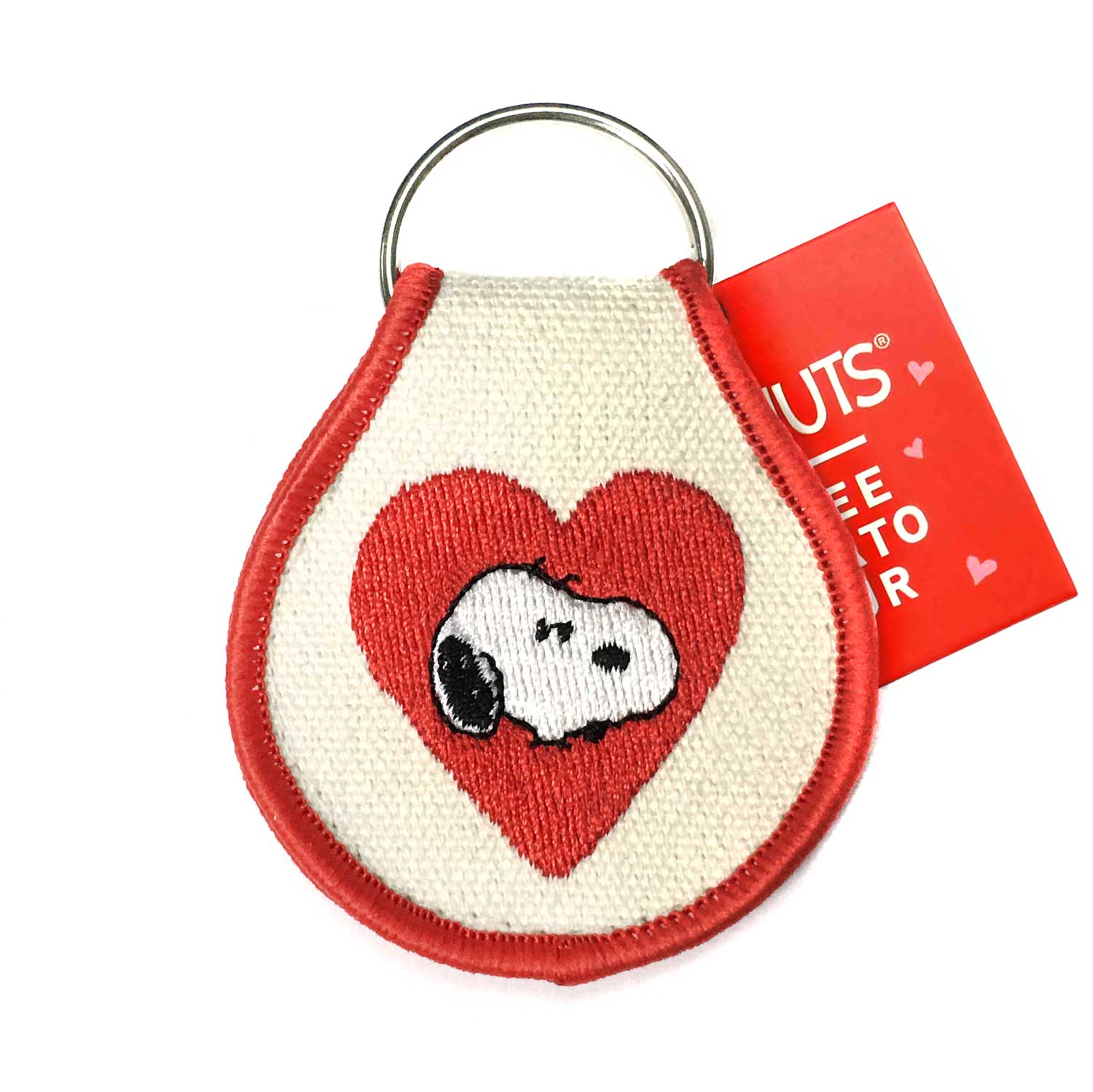 Heart-shaped keychain with Snoopy design and a red tag on a white background